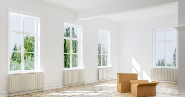 Large Empty White Room with Moving Boxes Inside