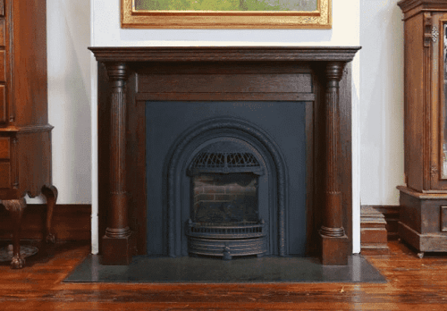 historic black metal fireplace in a victorian twin home in University City by Bellweather Design Build-png