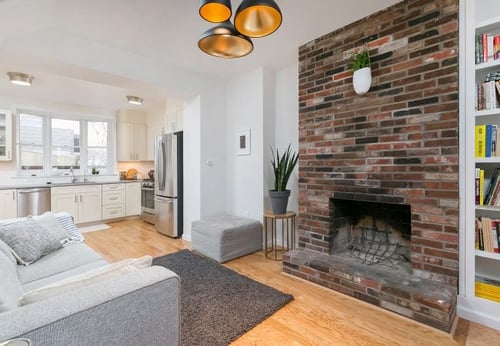 historic red brick fireplace in historic trinity home in center city by Bellweather Design Build